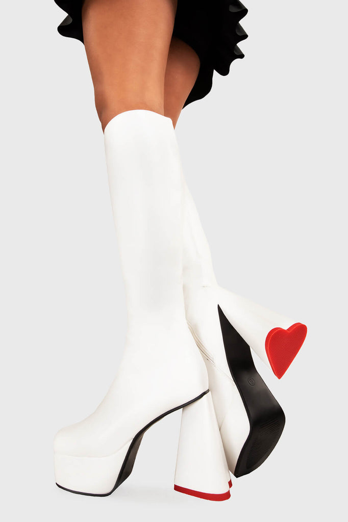 LOVEABLE 
  
  Sweet Talker Wide Calf Platform Knee High Boots in white faux leather. These platform boots feature a minimalist look with a heart shaped heel, keeping it nice and classy. Made with eco-friendly materials and 100% cruelty-free, these platform boots are as ethical as they are chic.
  
  - Platform Height
  - Knee length
  - Heart shaped heel
  - Red sole
  - Wide calf 
  - White zip
  - High Heel
  - 100% vegan 
  
  SKU: LMF 3313 - WhitePU - WIDE FIT