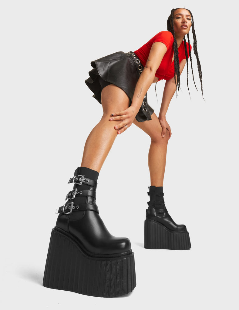 Count Me In Platform Ankle Boots in Red. These boots feature a lightning-shaped elastic gusset on red faux leather, with a chunky rubber platform sole. Made with eco-friendly materials and 100% cruelty-free!