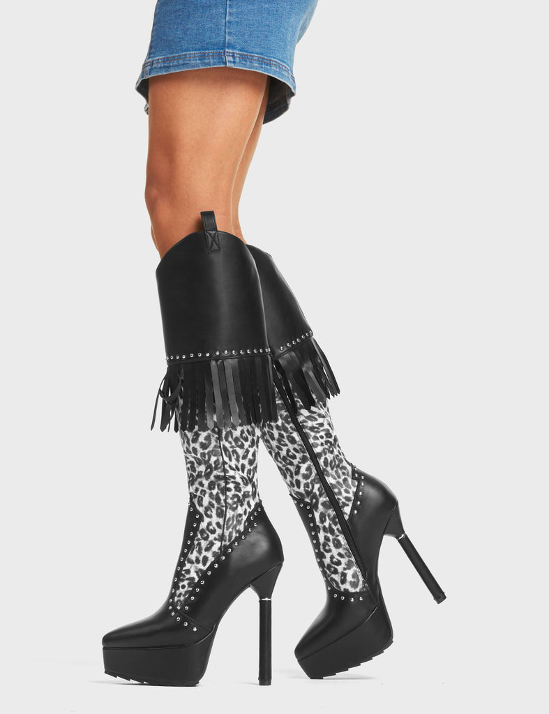 My Priority Western Platform Calf Boots. These western platform boots feature a leopard print upper with silver studs, black tassels and a signature thin silver ring platform heel. Made with eco-friendly materials and 100% cruelty-free.