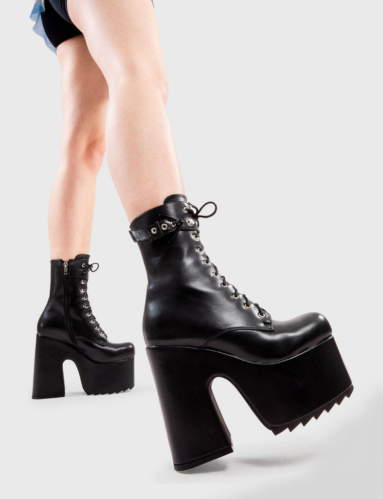 Dreamy Elevators
 
 Ayla Chunky Platform Ankle Boots in Black faux leather. These platform boots feature an adjustable strap across the top of the ankle as well as a lace up design, a twist on the basic lace up boot. Made with eco-friendly materials and 100% cruelty-free, these platform boots are as ethical as they are Dreamy.
 
 - Platform Height
 - Heel Height
 - Adjustable ankle strap with triangle buckle
 - Silver eyelets 
 - Black Zip
 - Shark's teeth grip
 - Chunky Platform sole
 - 100% vegan 
 
 SKU:
