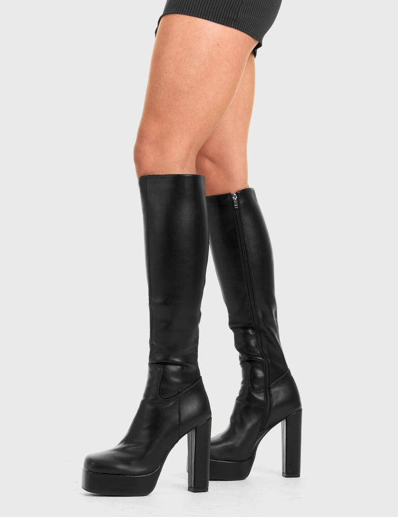 READY TO GO
  
  Game Player Platform Knee High Boots in Black faux leather. These platform boots feature a minimalist look, keeping it nice and classy. Made with eco-friendly materials and 100% cruelty-free, these platform boots are as ethical as they are chic.
  
  - Platform Height
  - Knee length
  - Black zip
  - High Heel
  - 100% vegan 
  
  SKU: LMF 3306 - BlackPU