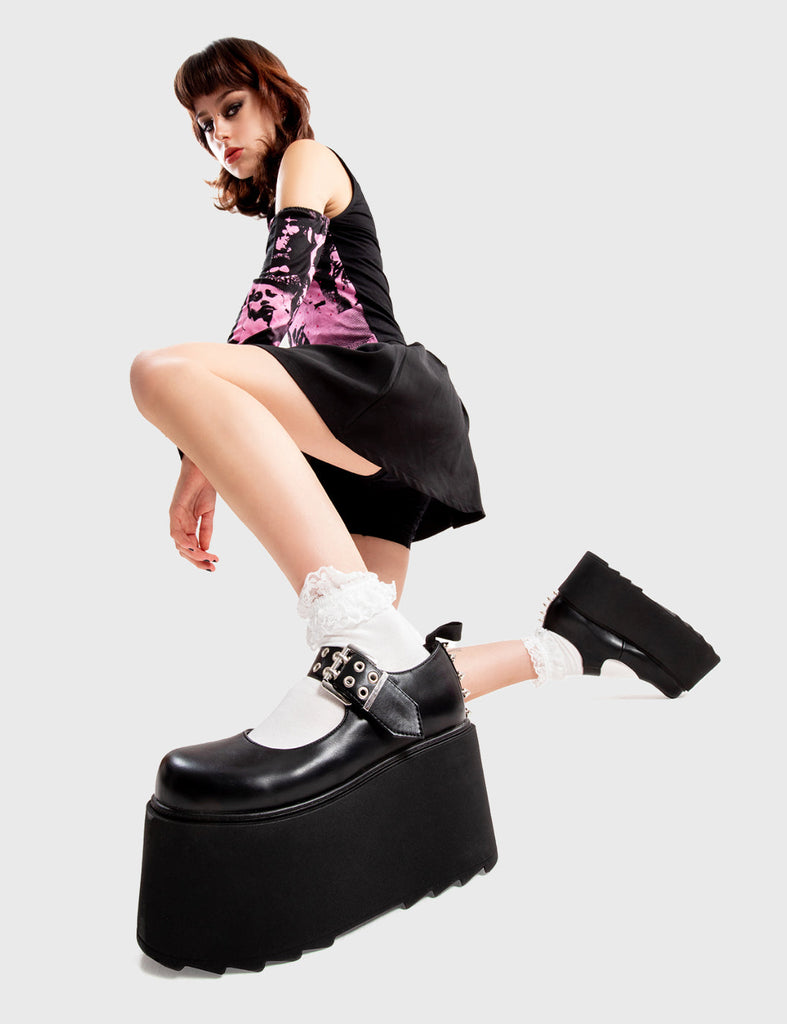 Step Out in Fashion
  
  My Story Chunky Platform Shoes in Black faux leather. These flatform shoes feature a strap with a double prong silver buckle and double eyelets, with spikes along the back. Made with eco-friendly materials and 100% cruelty-free, these platform boots are as ethical as they are Edgy
  
  - Platform Height
  - Large strap
  - Silver buckle and double eyelets
  - Spikes
  - Flatform Sole
  - Shark's Teeth Grip
  - 100% vegan 
  
  SKU: LMF 3135 - BlackPU