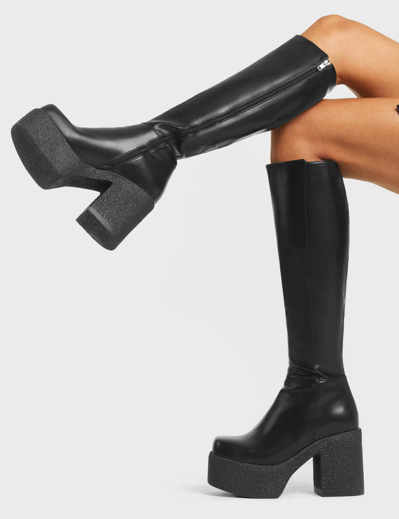 RED HANDED
  
  Called Out Chunky Platform Knee High Boots in Black faux leather. These platform boots feature a black minimalist design with a platformed chunky sole. Made with eco-friendly materials and 100% cruelty-free, these platform boots are as ethical as they are chic.
  
  - Platform Height
  - Knee high Length
  - Black Zip
  - Square Toe
  - Chunky Platform
  - 100% vegan 
  
  SKU: LMF 4098 - BlackPU