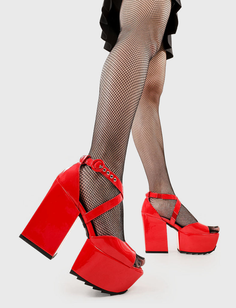 Vacay Vibes 
 
 Enemies Close Platform Sandals in Red Patent faux leather. These platform sandals feature an adjustable red ankle strap with silver eyelets, your stylish escapes. Made with eco-friendly materials and 100% cruelty-free, these platform boots are as ethical as they are Platform Paradise.
 
 - Platform Height
 - Heel Height
 - Adjustable red strap
 - Shark's teeth grip
 - Silver eyelets with 'O' shaped buckle
 - Chunky Platform sole
 - Round Toe 
 - 100% vegan 
 
 SKU: LMF 2519 - RedPAT