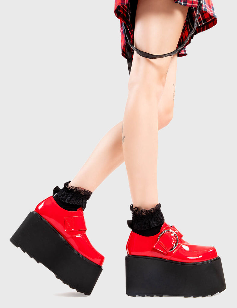 Step Out in Fashion
  
  Grounded Chunky Platform Shoes in Red Patent. These flatform shoes feature a large strap with a large silver 'O' ring buckle. Made with eco-friendly materials and 100% cruelty-free, these platform boots are as ethical as they are Edgy
  
  - Platform Height
  - Large strap
  - Silver buckle and eyelets
  - Flatform Sole
  - Shark's Teeth Grip
  - 100% vegan 
  
  SKU: LMF 3133 - RedPAT