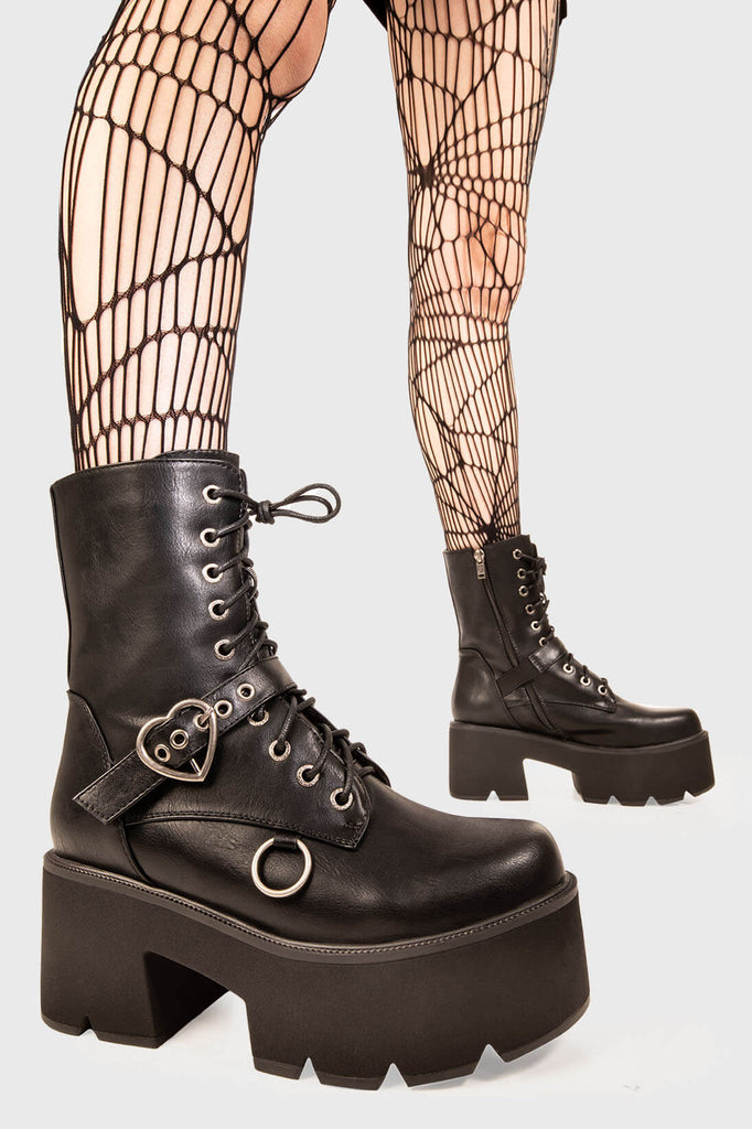 Ice Cold.
 
 Heartles Chunky Platform Boots in Black faux leather. These black vegan Platform Boots feature lace up detail with a black strap across the upper with a silver heart shaped buckle, will leave them begging for more. Made with eco-friendly materials and 100% cruelty-free!
 
 
 - Platform Height: 3 inch
 - Black laces silver eyelets 
 - Black strap silver heart buckle
 - Black Zipper 
 - Silver 'O' ring on the side 
 - Chunky Platform sole
 - Round Toe
 - 100% vegan 
 
 SKU: LMF 1846 - BlackPU