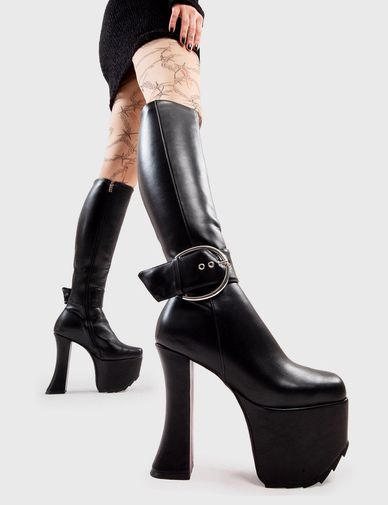 Not Your Basic Boots!
  
  Kick Start Platform Knee High Boots in Black faux leather. These platform boots feature a minimalist design, with a large Silver buckle around the ankle on our platform sole and curved heel. Made with eco-friendly materials and 100% cruelty-free, these platform boots are as ethical as they are Trendy.
  
  - Platform Height
  - Heel Height
  - Black zip
  - Large Silver buckle and eyelets
  - Curved Heel
  - Platform Sole
  - 100% vegan 
  
  SKU: LMF 2996 - BlackPU