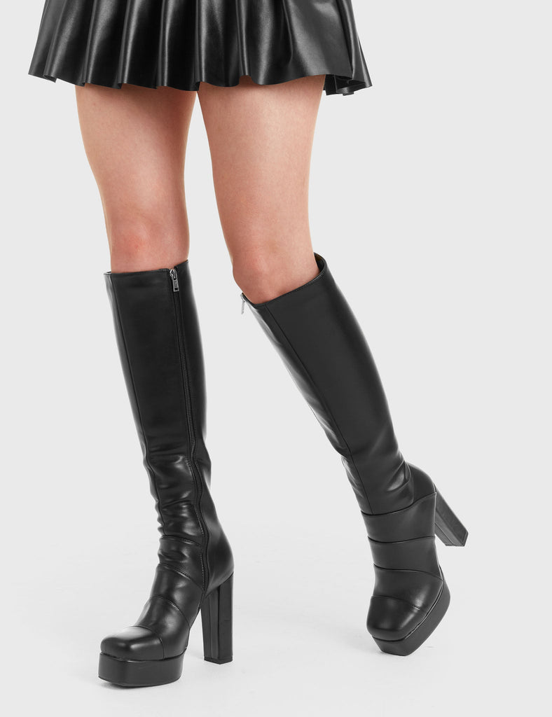 READY TO GO
  
  Fashionably Late Platform Knee High Boots in Black faux leather. These platform boots feature a minimalist look with a stitching designs, keeping it nice and classy. Made with eco-friendly materials and 100% cruelty-free, these platform boots are as ethical as they are chic.
  
  - Platform Height
  - Knee length
  - Layered stitching
  - Black zip
  - High Heel
  - 100% vegan 
  
  SKU: LMF 3308 - BlackPU