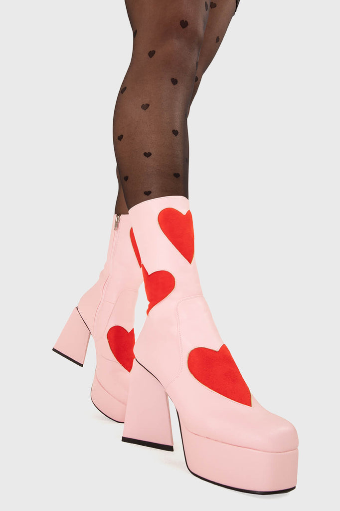 LOVEY DOVEY 
  
  Letter To My Lover Platform Ankle Boots in Pink faux leather. These platform boots feature a pink boot with big red heart all over. Made with eco-friendly materials and 100% cruelty-free, these platform boots are as ethical as they are chic.
  
  - Platform Height
  - Big red hearts
  - Calf length
  - Triangle heel
  - High Heel
  - 100% vegan 
  
  SKU: LMF 3337 - PinkPU/RedHeart