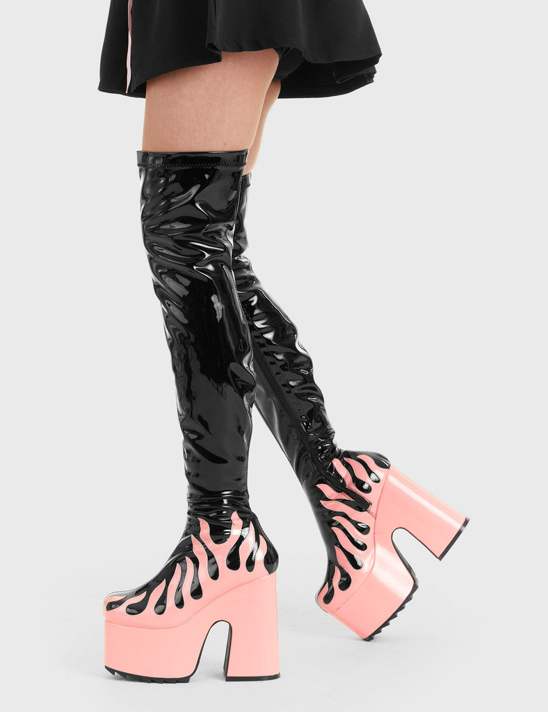 Bring The Heat 
  
  Light Up Platform Thigh High Boots in Black Patent. These platform boots feature a Pink Patent flame as well as a Pink Patent Platform, elevate your fashion game. Made with eco-friendly materials and 100% cruelty-free, these platform boots are as ethical as they are Hot.
  
  - Platform Height
  - Heel Height
  - Black Zip
  - Pink Patent Flame
  - Chunky Platform sole
  - Shark's teeth grip 
  - 100% vegan 
  
  SKU: