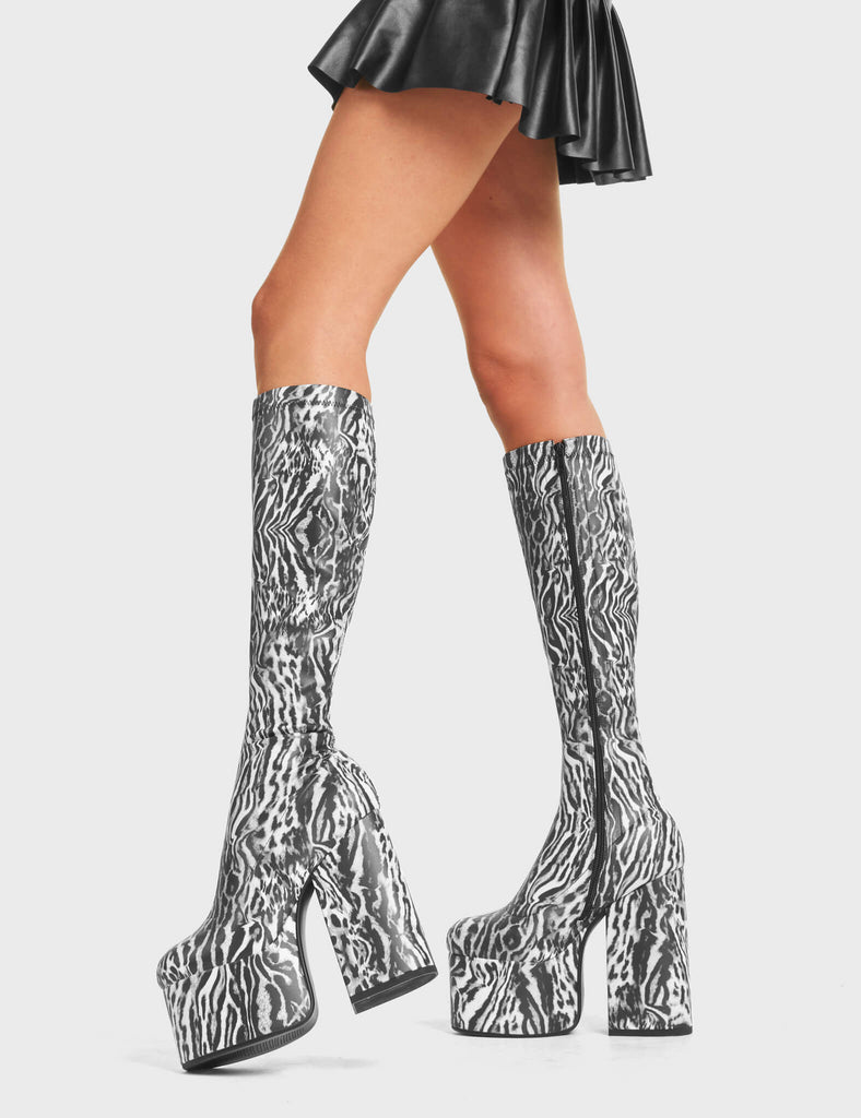 Messenger Platform Knee High Boots in Tiger print. Feature a minimalist design, platform sole and a stretch fit.