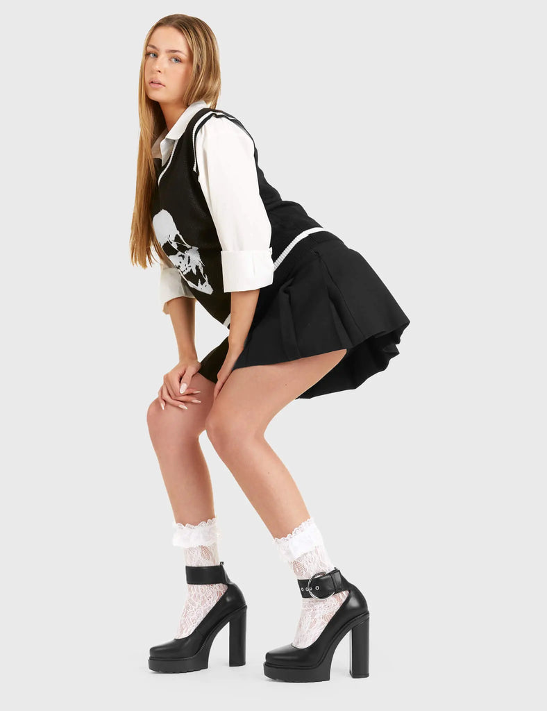 Trend Setter
  
  Midnight Glow Platform Heels in Black faux leather. These platform heels feature a large strap around the ankle with silver eyelets and a large silver 'O' ring buckle. They are the perfect way to elevate any look. Made with eco-friendly materials and 100% cruelty-free, these platform boots are as ethical as they are Trendy.
  
  - Platform Height
  - Heel Height
  - Large Strap and Silver 'O' ring buckle
  - High Heel
  - Shark's teeth grip
  - 100% vegan 
  
  SKU: LMF 2956 - BlackPU