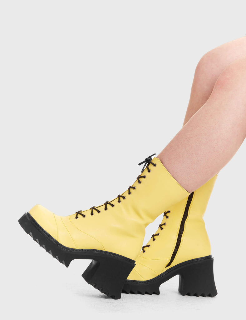 LACED UP
  
  On A Buzz Chunky Platform Ankle Boots in yellow faux leather. These vegan western Boots feature black laces and a shark teeth grip sole, very chic. Made with eco-friendly materials and 100% cruelty-free, these boots are as ethical as they are edgy!
  
  
  - Chunky Platform
  - Calf length
  - Shark teeth grip
  - Black laces
  - Rounded toe 
  - 100% vegan 
  
  SKU: LMF 3730 - LemonPU