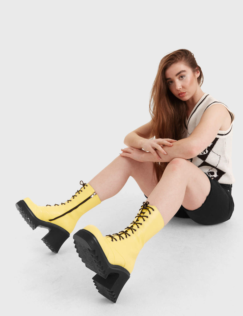 LACED UP
  
  On A Buzz Chunky Platform Ankle Boots in yellow faux leather. These vegan western Boots feature black laces and a shark teeth grip sole, very chic. Made with eco-friendly materials and 100% cruelty-free, these boots are as ethical as they are edgy!
  
  
  - Chunky Platform
  - Calf length
  - Shark teeth grip
  - Black laces
  - Rounded toe 
  - 100% vegan 
  
  SKU: LMF 3730 - LemonPU