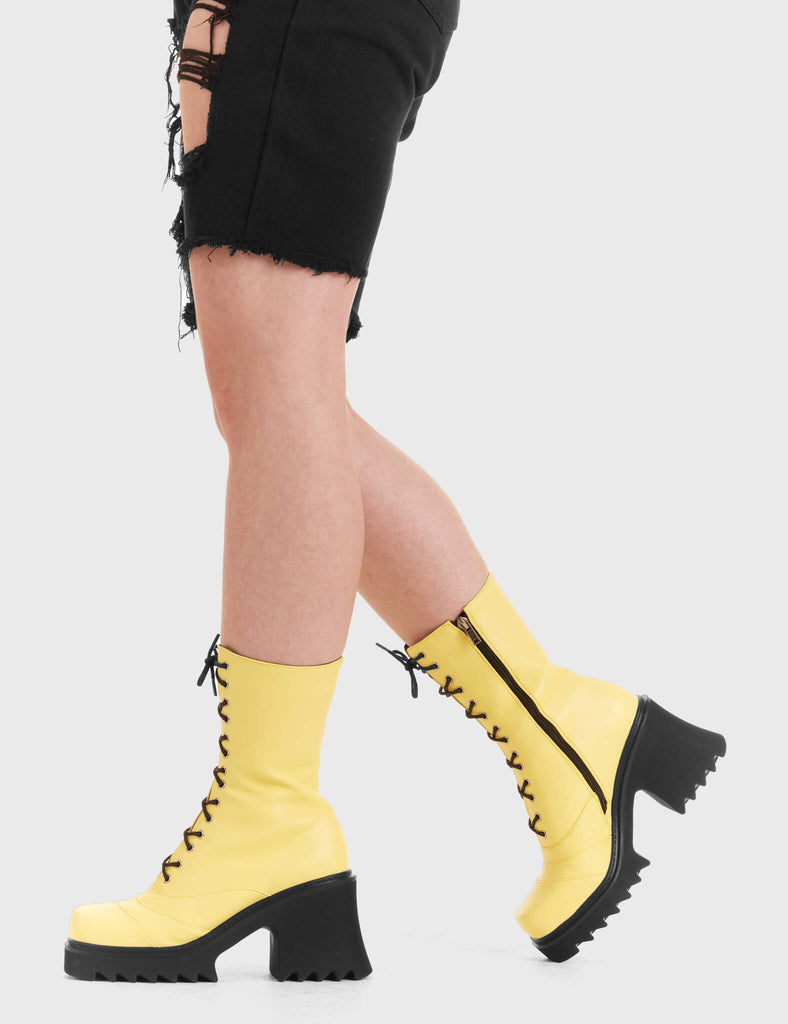 LACED UP
  
  On A Buzz Chunky Platform Ankle Boots in yellow faux leather. These vegan western Boots feature black laces and a shark teeth grip sole, very chic. Made with eco-friendly materials and 100% cruelty-free, these boots are as ethical as they are edgy!
  
  
  - Chunky Platform
  - Calf length
  - Shark teeth grip
  - Black laces
  - Rounded toe 
  - 100% vegan 
  
  SKU: LMF 3730 - LemonPU