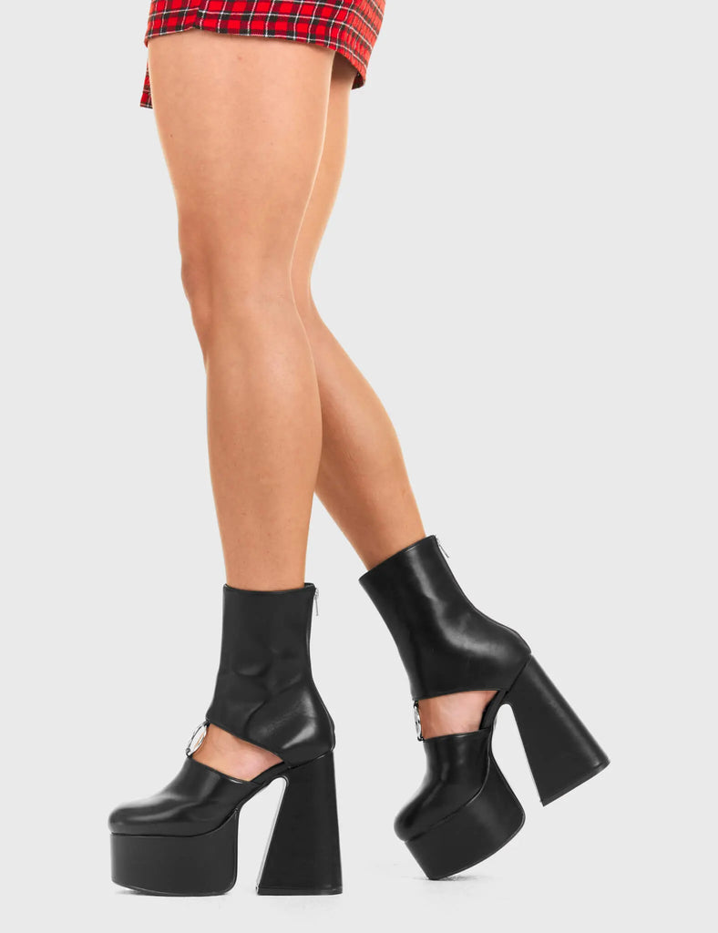 RING ME
  
  Ring Me Platform Ankle Boots Ankle Boots in Black faux leather. These platform boots feature a minimalist look with a cut out design, keeping it nice and classy. Made with eco-friendly materials and 100% cruelty-free, these platform boots are as ethical as they are chic.
  
  - Platform Height
  - calf length
  - Cut out design
  - Silver circle buckle
  - Flared heel
  - High Heel
  - 100% vegan 
  
  SKU: LMF 3354 - BlackPU