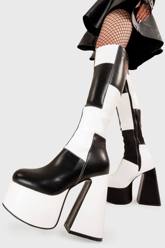 TIME TO DANCE
  
  Runway Platform Knee High Boots in Black and white faux leather. These platform boots feature a black and white patch work design with a triangle heel, keeping it nice and classy. Made with eco-friendly materials and 100% cruelty-free, these platform boots are as ethical as they are chic.
  
  - Platform Height
  - Knee high length
  - Patch work design
  - Triangle heel
  - High Heel
  - 100% vegan 
  
  SKU: LMF 3361 - BlackPU/WhitePU