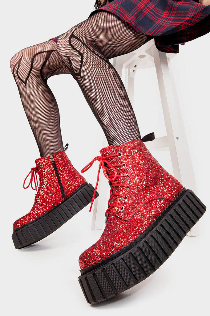 Twinkle Toes
  
  Shooting Star Chunky Ankle Creeper Boot in Red Glitter. These red vegan Boots feature our iconic glitter detail througout with adjustable lace up detail, sparkle with every step! Made with eco-friendly materials and 100% cruelty-free, these platform boots are as ethical as they are glowing!
  
  
  - Platform Height: 2.3 inch
  - Black zipper 
  - Black laces and silver eyelets 
  - Chunky Creeper sole
  - Round Toe
  - 100% vegan 
  
  SKU: LMF 2007 - RedGlitter