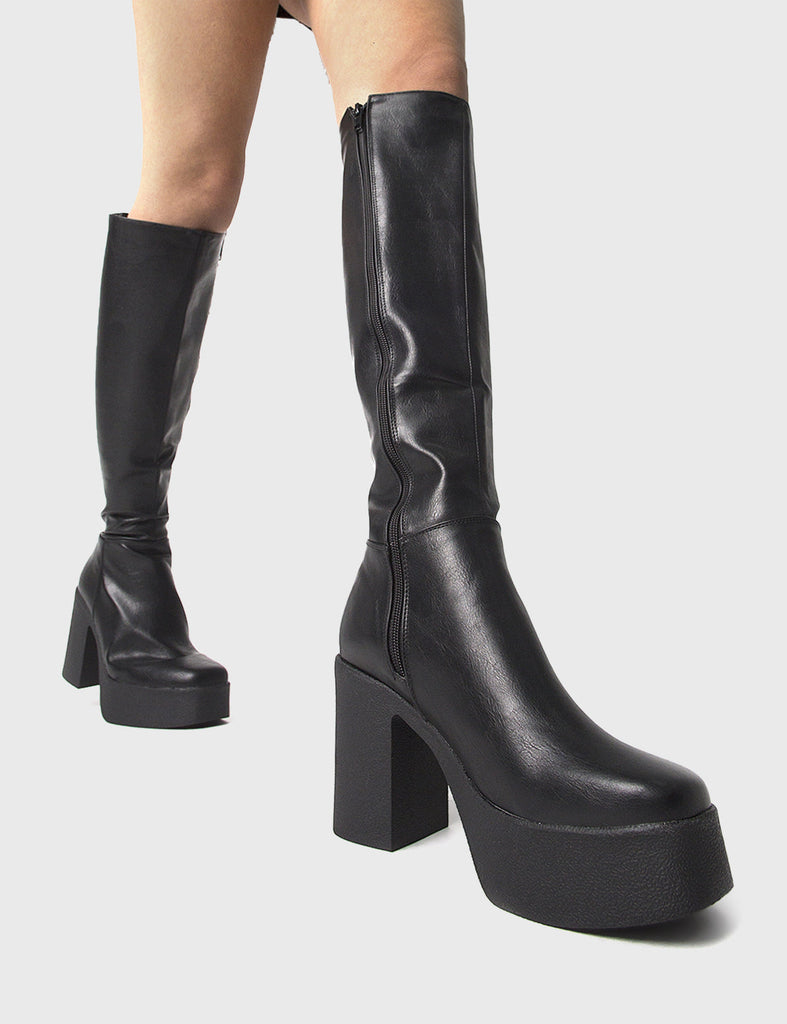 THE TRENDING ONE
  
  Slick Nicks Platform Knee High Boots in Black faux leather. These Black vegan Boots feature an elegant clutter free design and a Platform sole and heel, perfect for adding height and style to any outfit. Made with eco-friendly materials and 100% cruelty-free, these boots are as ethical as they are stylish.
  
  
  - Platform Height: 1.25 inch
  - Heel Height: 4 inch
  - Knee High length
  - Black zipper 
  - Platform sole
  - Square toe 
  - 100% vegan 
  
  SKU: LMF 0856 - BlackPU