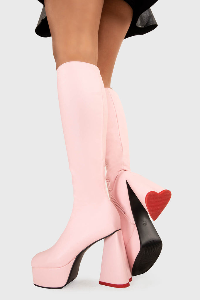 LOVEABLE 
  
  Sweet Talker Wide Calf Platform Knee High Boots in Pink faux leather. These platform boots feature a minimalist look with a heart shaped heel, keeping it nice and classy. Made with eco-friendly materials and 100% cruelty-free, these platform boots are as ethical as they are chic.
  
  - Platform Height
  - Knee length
  - Heart shaped heel
  - Red sole
  - Wide calf 
  - Pink zip
  - High Heel
  - 100% vegan 
  
  SKU: LMF 3313 - PinkPU - WIDE FIT