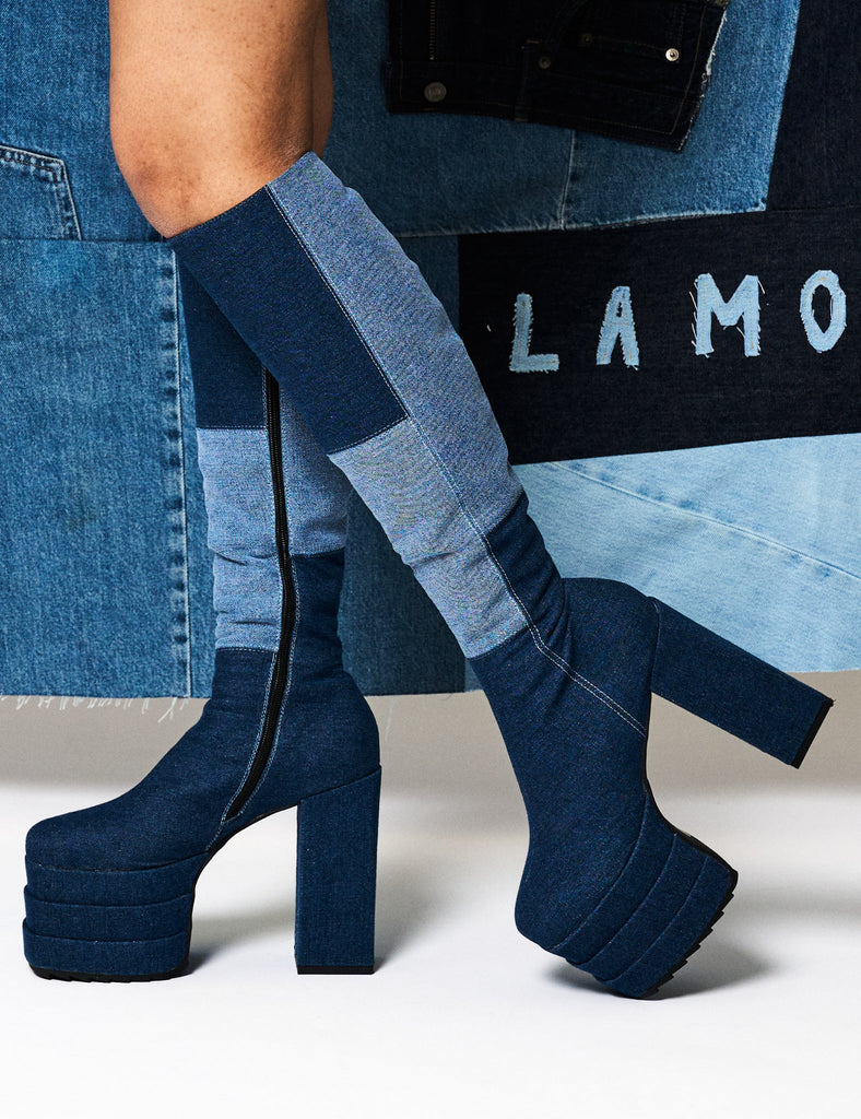 Denim Dolls
  
  Talk Of The Town Platform Knee High Boots in Denim. These platform boots feature our iconic Denim finish on a double stack platform sole, take center stage with these jaw dropping boots. Made with eco-friendly materials and 100% cruelty-free, these platform boots are as ethical as they are Jaw dropping.
  
  - Platform Height
  - Heel Height
  - Black Zip 
  - Knee high length
  - Shark's teeth grip
  - Chunky Platform sole
  - Round Toe 
  - 100% vegan 
  
  SKU: LMF 2701 - Denim