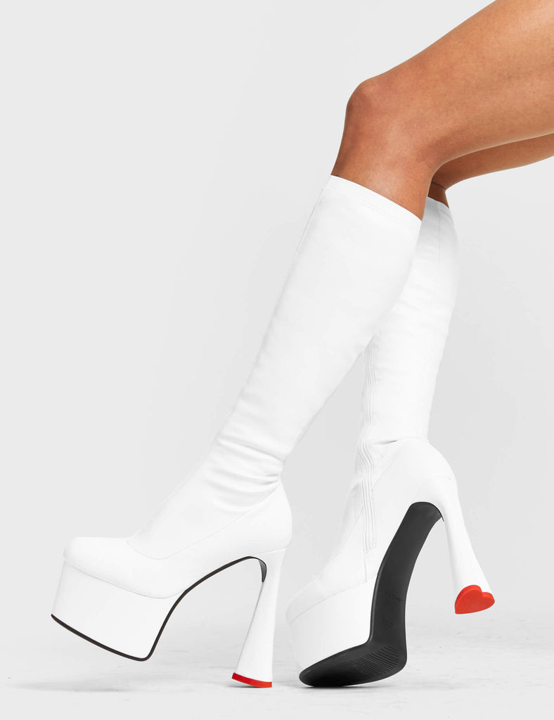 FOREVER TOGETHER
 
 Talk Platform Knee High Boots in White Stretch faux leather. These platform boots feature on our platform sole and highlights our heart shaped heel with a red heart at the bottom. Made with eco-friendly materials and 100% cruelty-free, these platform boots are as ethical as they are Legendary!
 
 - Platform Height
 - Heel Height
 - Black Zip
 - Knee High Length
 - Stretch Upper
 - Platform Sole
 - Heart Heel
 - Heart Detail
 - Round Toe
 - 100% vegan
 
 SKU: LMF 4471 - WhitePU