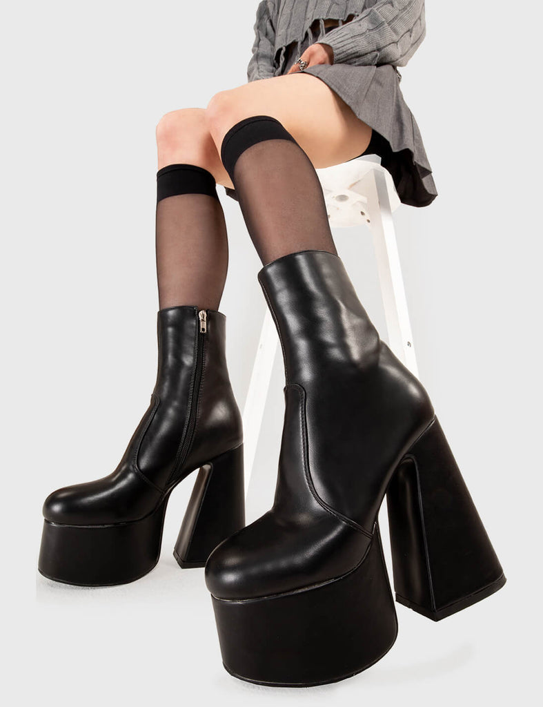 NOT YOUR AVERAGE BOOT
  
  Under Cover Platform Ankle Boots in Black faux leather. These platform boots feature a minimalist look with a flared heel, keeping it nice and classy. Made with eco-friendly materials and 100% cruelty-free, these platform boots are as ethical as they are chic.
  
  - Platform Height
  - Ankle length
  - Flared heel
  - High Heel
  - 100% vegan 
  
  SKU: LMF 3349 - BlackPU