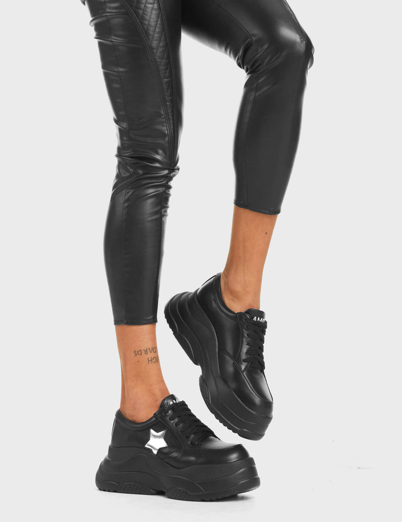Venus Chunky Platform Sneakers in Black. Feature black lace-up fastening and a silver star.