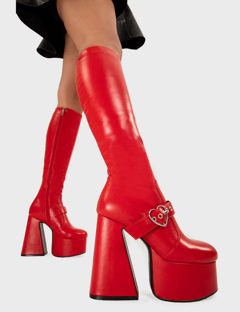 YOU STOLE MY HEART
  
  Walk With Love Platform Knee High Boots in Red faux leather. These platform boots feature a minimalist look with a Flared heel, and an adjustable strap. Made with eco-friendly materials and 100% cruelty-free, these platform boots are as ethical as they are chic.
  
  - Platform Height
  - Knee high 
  - Silver heart buckle
  - Flared heel
  - High Heel
  - 100% vegan 
  
  SKU: LMF 3358 - RedPU