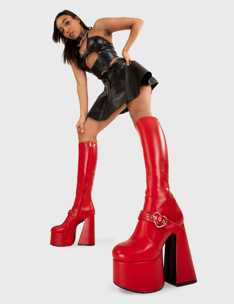 YOU STOLE MY HEART
  
  Walk With Love Platform Knee High Boots in Red faux leather. These platform boots feature a minimalist look with a Flared heel, and an adjustable strap. Made with eco-friendly materials and 100% cruelty-free, these platform boots are as ethical as they are chic.
  
  - Platform Height
  - Knee high 
  - Silver heart buckle
  - Flared heel
  - High Heel
  - 100% vegan 
  
  SKU: LMF 3358 - RedPU